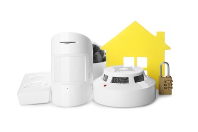 Photo of House model, CCTV camera, remote control, lock, smoke and movement detectors on white background. Home security system