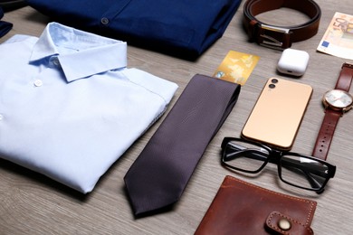 Composition with clothes and accessories on wooden background. Packing for business trip