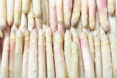 Fresh ripe white asparagus as background, top view