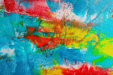 Strokes of colorful acrylic paints on canvas, closeup