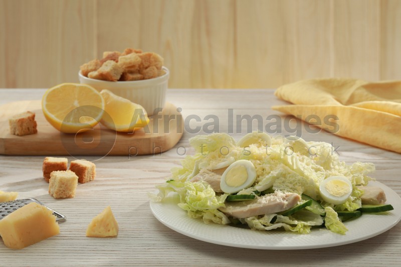 Delicious salad with Chinese cabbage, eggs and meat served on wooden table, space for text