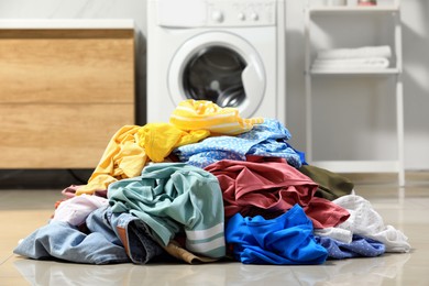 Pile of dirty clothes on floor in laundry room