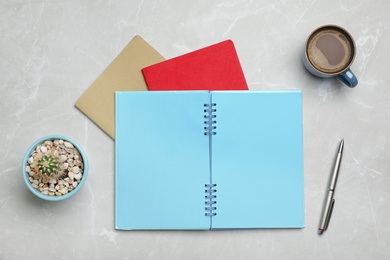 Flat lay composition with notebooks and cup of coffee on grey background
