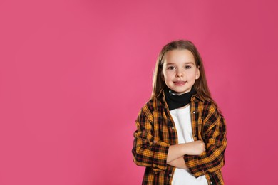 Cute little girl wearing stylish bandana on pink background, space for text
