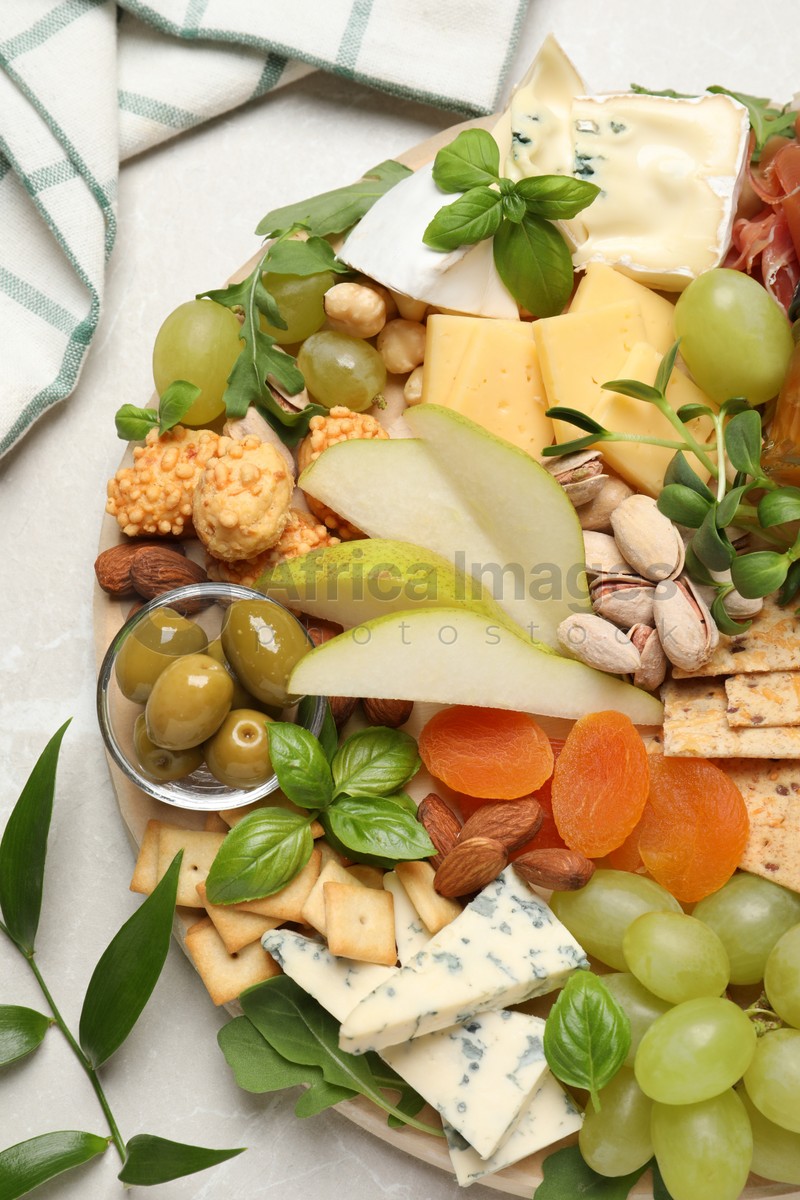 Different tasty appetizers on light table, flat lay
