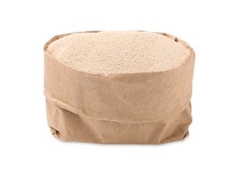 Photo of Granulated yeast in paper bag on white background