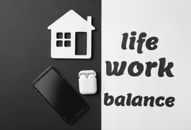Wooden house, wireless earphones and smartphone on color background, flat lay. Life work balance concept