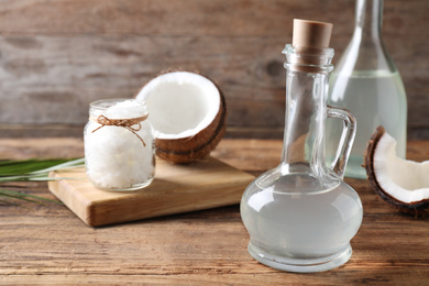 Coconut oil in glass jug on wooden table