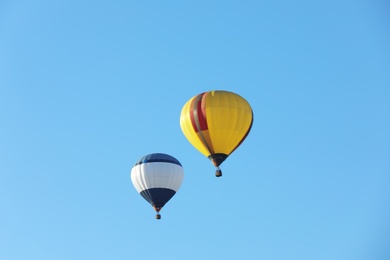 Colorful hot air balloons flying in blue sky