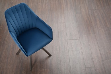 Stylish blue armchair on floor, above view. Space for text