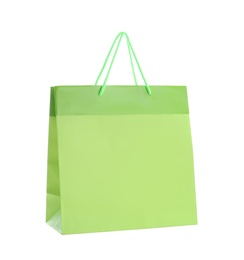 Green paper shopping bag isolated on white