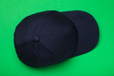 Baseball cap on green background, top view. Mock up for design