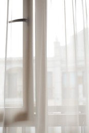 Window behind white curtain indoors in morning