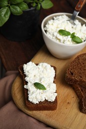 Photo of Bread with cottage cheese and basil on table