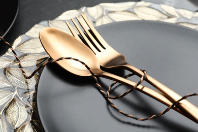 Stylish table setting with golden cutlery, closeup