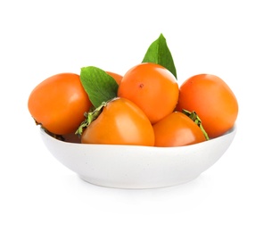 Bowl with delicious persimmons and green leaves  isolated on white