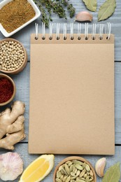 Photo of Blank recipe book and different ingredients on grey wooden table, flat lay. Space for text