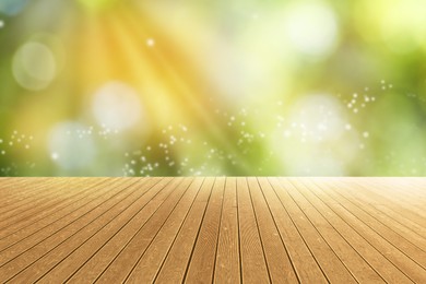 Empty wooden surface against blurred green background. Bokeh effect