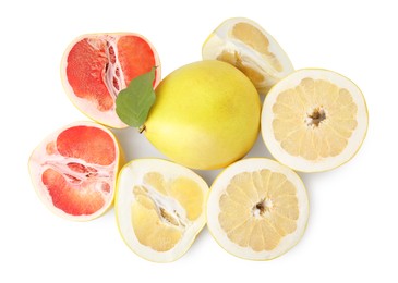 Photo of Cut and whole fresh pomelo fruits on white background, top view
