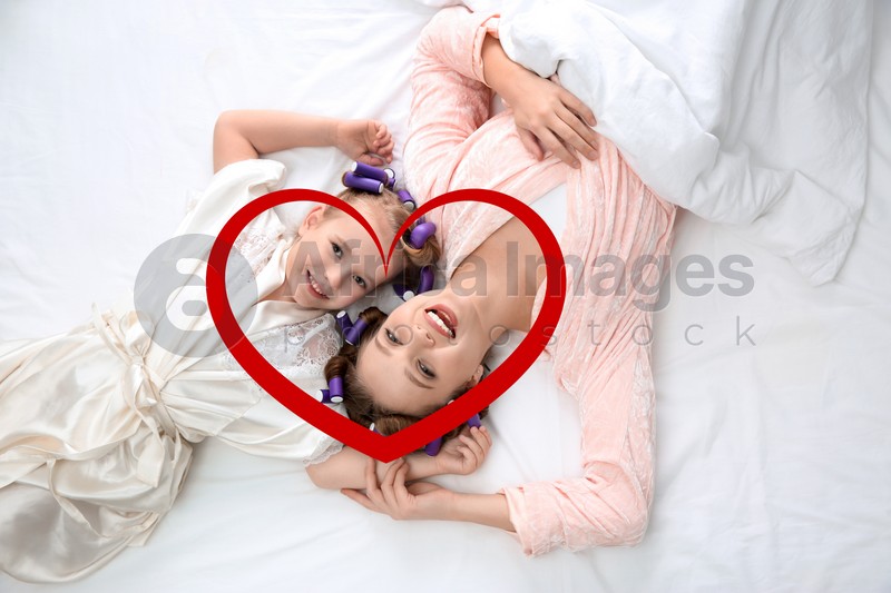 Illustration of red heart and happy mother with daughter with curlers lying on bed, top view