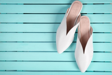 Photo of Pair of female shoes on wooden background, top view