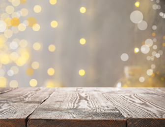 Empty wooden surface against blurred background with bokeh effect. Christmas time