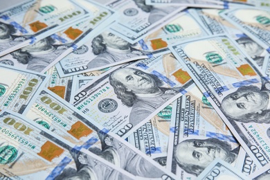 Many dollar banknotes as background, closeup view