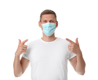Male volunteer in mask on white background. Protective measures during coronavirus quarantine