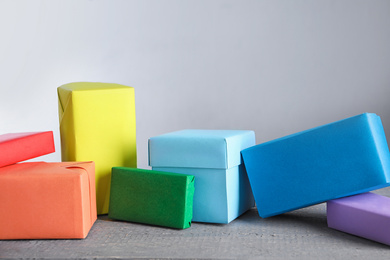 Bright boxes on grey table. Rainbow colors
