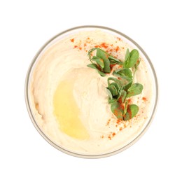 Photo of Bowl of tasty hummus with pea leaves and paprika isolated on white, top view