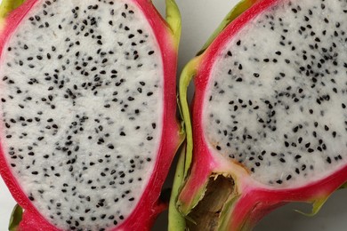 Photo of Top view of cut dragon fruit (pitahaya) on white background, closeup