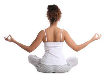 African-American woman meditating on white background, back view
