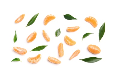 Composition with tangerine segments and leaves on white background, top view