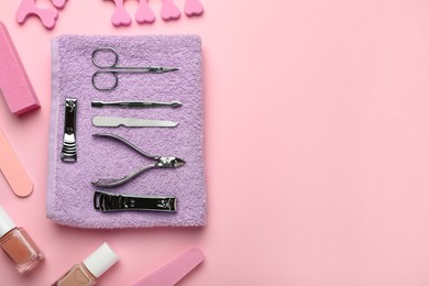 Photo of Set of manicure tools and accessories on pink background, flat lay. Space for text