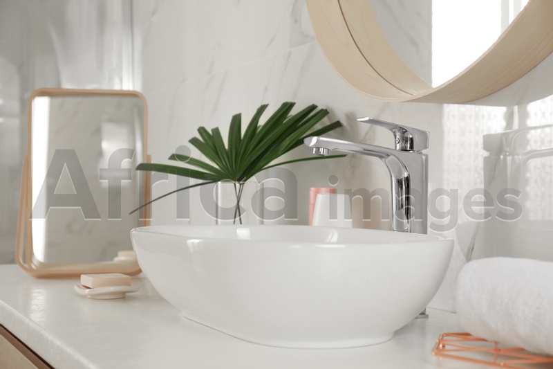 Stylish bathroom interior with vessel sink and decor elements