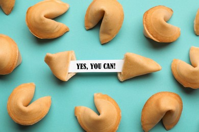 Tasty fortune cookies with prediction Yes, you can! on cyan background, above view