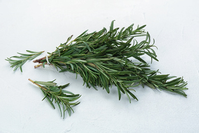 Bunch of fresh rosemary on white table