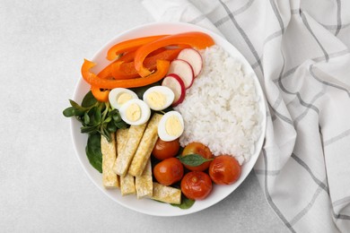 Photo of Delicious poke bowl with vegetables, eggs and tofu on light grey table, top view