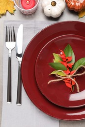 Beautiful place setting with autumn decor on grey table, flat lay