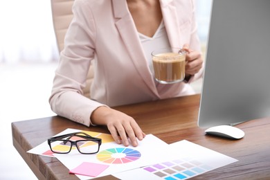 Photo of Female designer working at desk in office, closeup