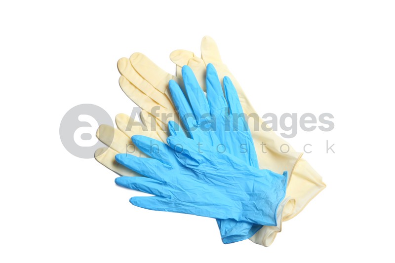 Different protective gloves on white background, top view. Medical item
