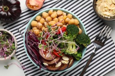 Photo of Delicious vegan bowl with broccoli, red cabbage and chickpeas on white table, flat lay