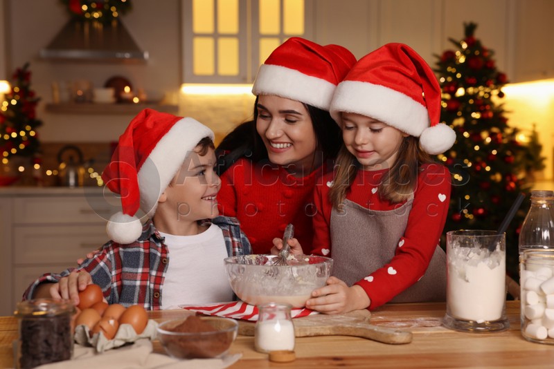 Happy family making dough for Christmas cookies at home