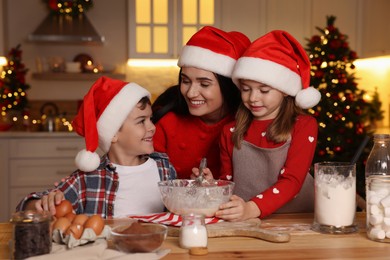 Happy family making dough for Christmas cookies at home