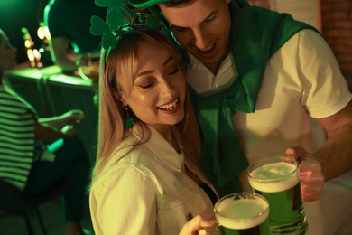 Couple with beer celebrating St Patrick's day in pub
