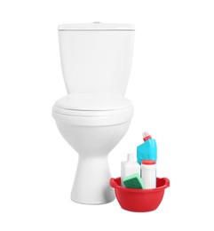 Toilet bowl and cleaning supplies on white background