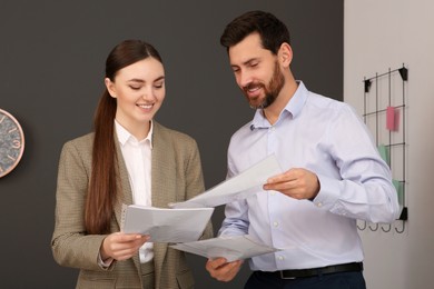 Photo of Businesspeople working together with documents in office