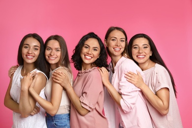Happy women on pink background. Girl power concept