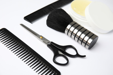 Professional hairstyling tools on white background, closeup