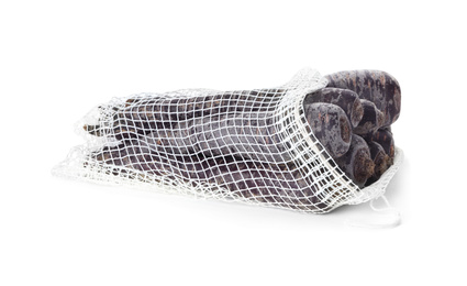 Raw black carrots in mesh bag isolated on white